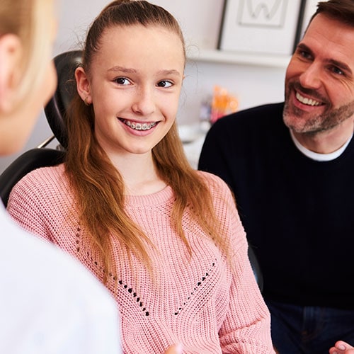 happy-girl-her-dad-during-dental