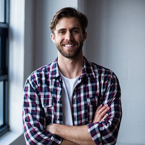 portrait-smiling-young-man-standing-by