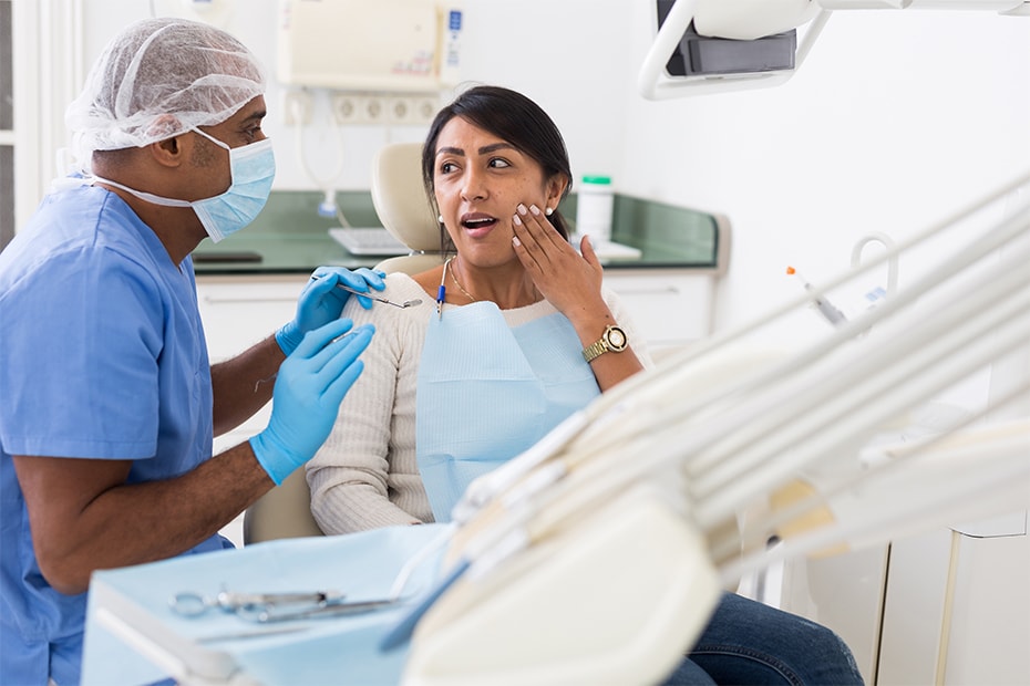 upset-hispanic-woman-sitting-dental-chair